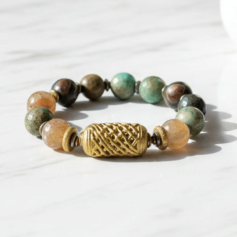 Beaded bracelet with a gold accent on a white background