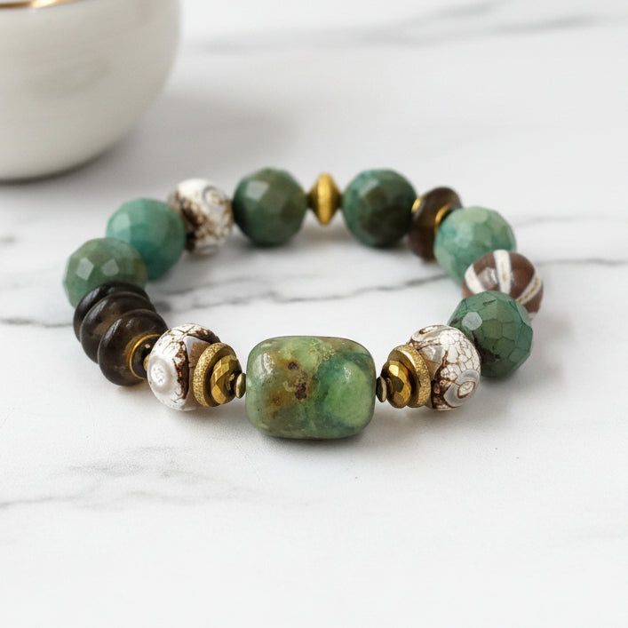 A multicolored beaded bracelet with a mix of green, brown, and white beads, featuring metallic accents.
