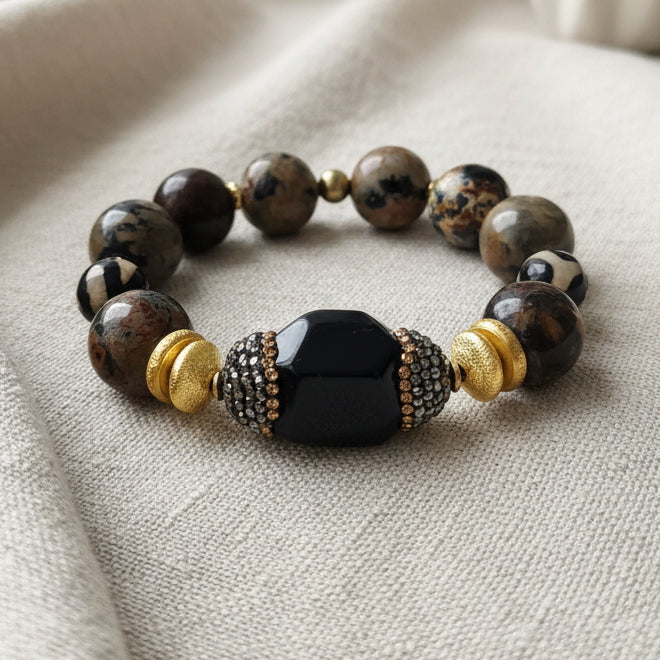 A multicolor beaded bracelet with a black onyx centerpiece and gold-colored accents.