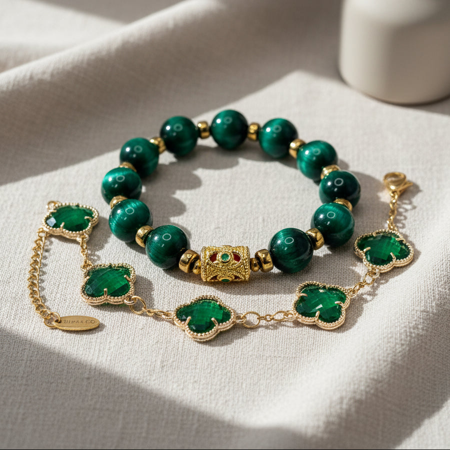 Green beaded bracelet with gold accents on a white surface with decorative plants.
