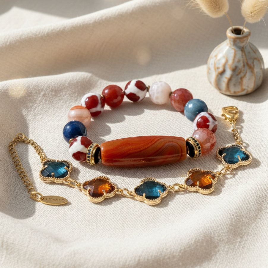 Colorful beaded bracelet with gold chain on a white surface
