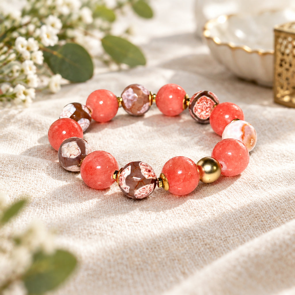 Bracelet with pink and gold beads on a white surface
