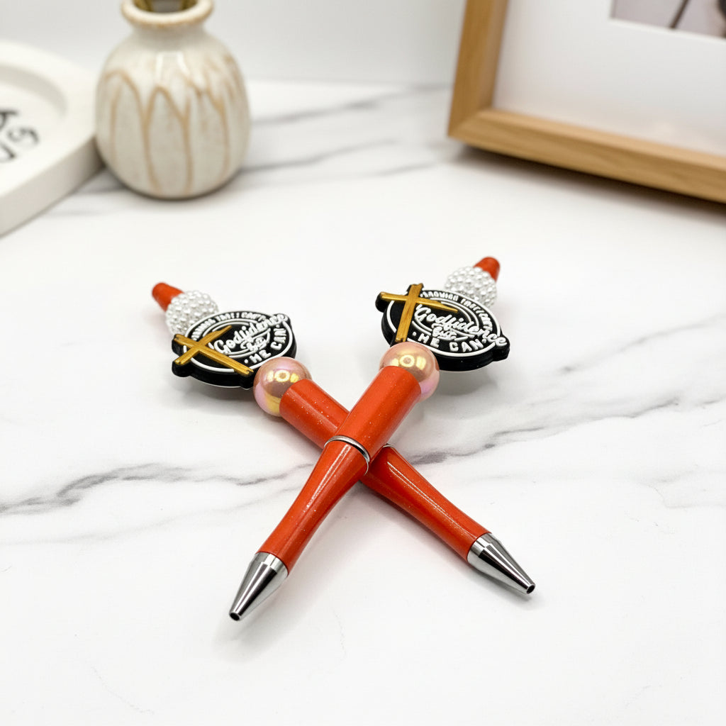 Two orange pens with black accents and a vase on a white background