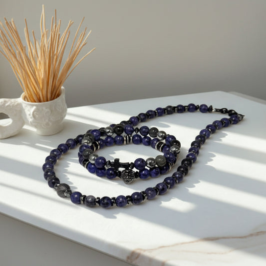 Necklace with blue and black beads on a white surface