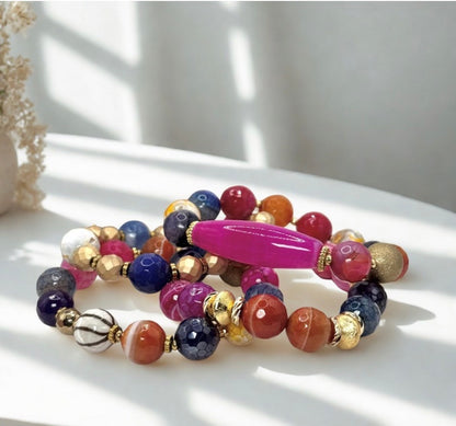 Colorful beaded bracelet with a pink accent on a white surface