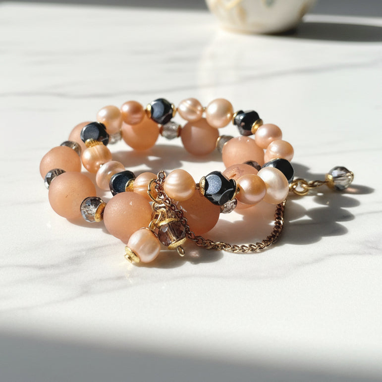 Stack of pearl and beaded bracelets on a white background