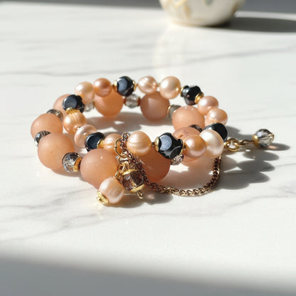 Stack of pearl and beaded bracelets on a white background