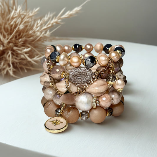 Multistrand beaded bracelet with pearls and crystals on a white surface