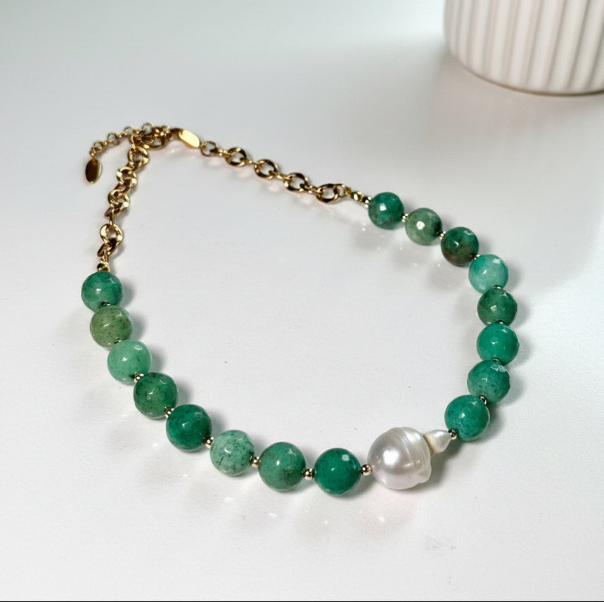 Natural green Chrysoprase beaded necklace with a baroque pearl centerpiece on a white background