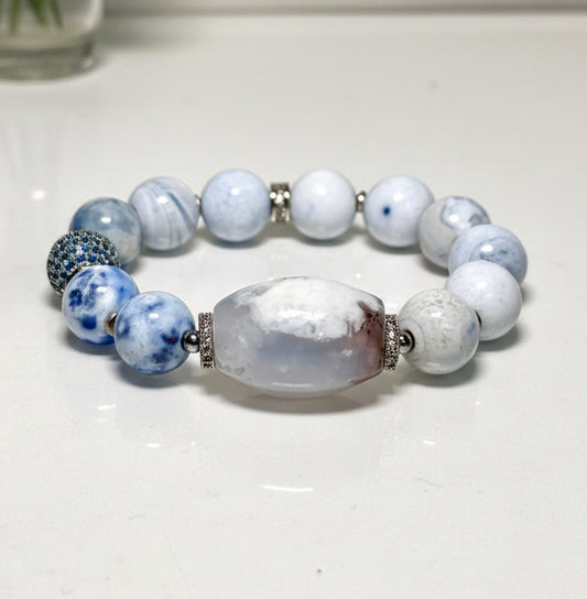 Beaded bracelet with blue and white beads on a light background