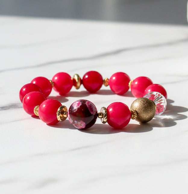 Beaded bracelet with pink and gold beads on a white background