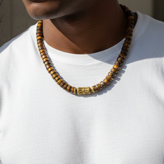 Rondelle tiger's eye necklace with a brass center worn by a black male wearing a white tshirt