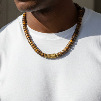 Rondelle tiger's eye necklace with a brass center worn by a black male wearing a white tshirt