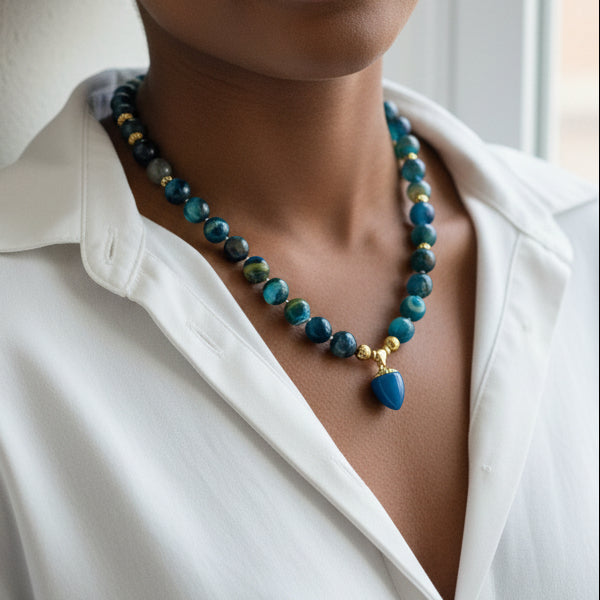 Blue and green beaded agate necklace on a model wearing a white shirt