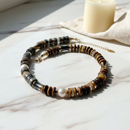 Labradorite and tiger's eye necklace accented with gold and pearls on a white background