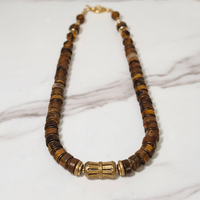 Necklace with brown and gold beads on a white background