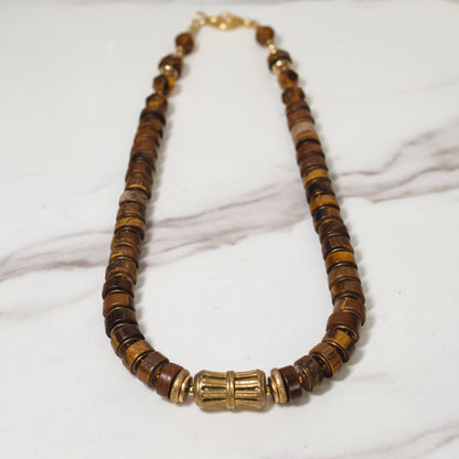 Necklace with brown and gold beads on a white background