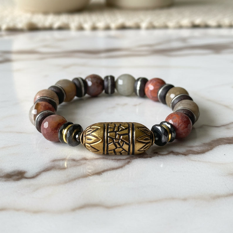 Multicolored beaded bracelet with a gold accent on a white background