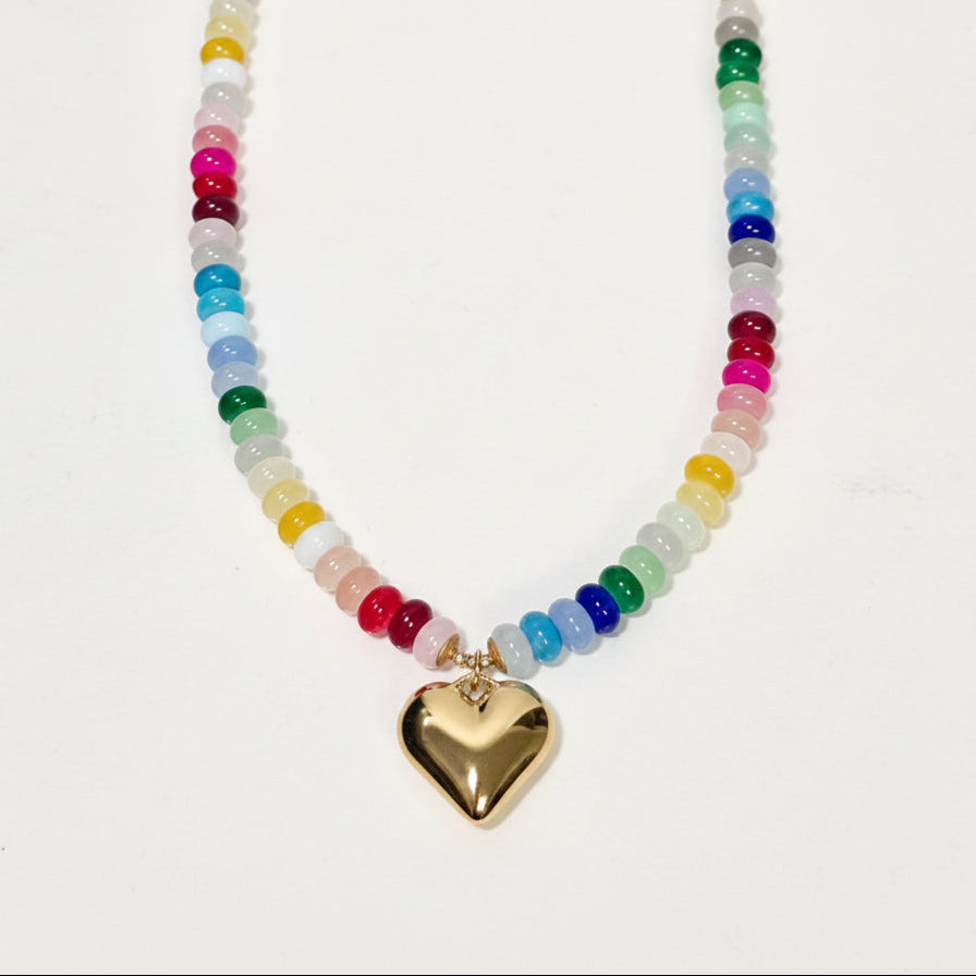 Necklace with multicolored beads and a gold heart pendant on a white background