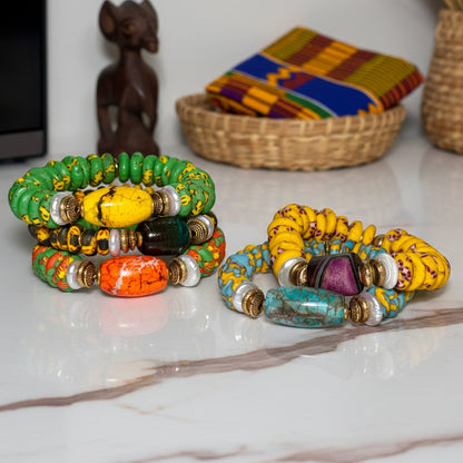 Colorful beaded bracelets on a white surface