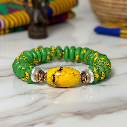 Green and yellow beaded bracelet on a white background