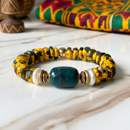 Beaded bracelet with yellow, black, and gold beads on a white background