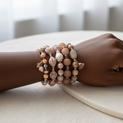Set of beaded bracelets on a black female model and linen fabric 
