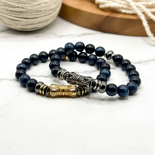 Blue Tiger Eye beaded bracelet with gold and silver accents on a white background