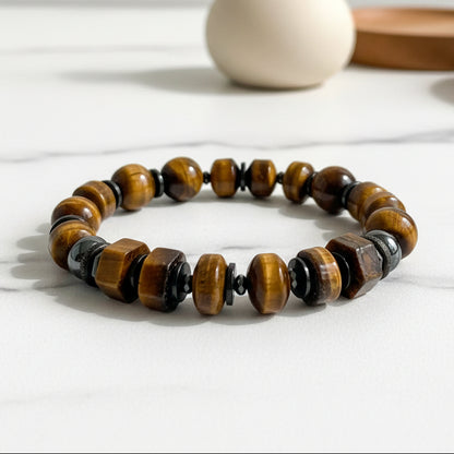 Beaded bracelet with brown and black beads on a white surface