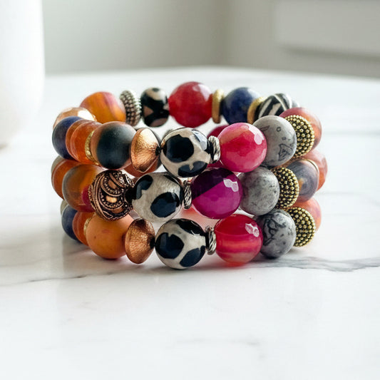 Multicolored beaded bracelet on a white surface with a neutral background