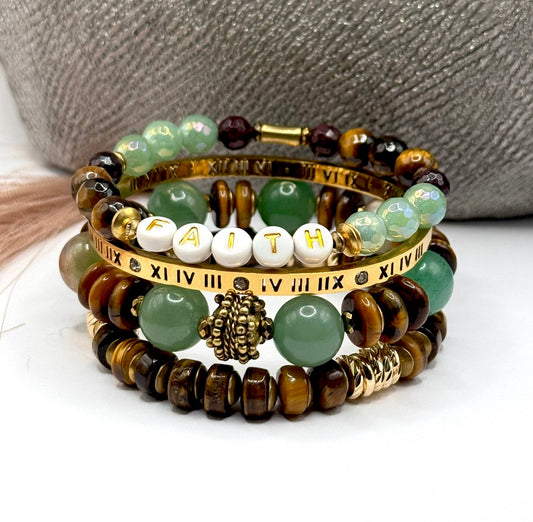 Stack of beaded bracelets with 'FAITH' on a white surface