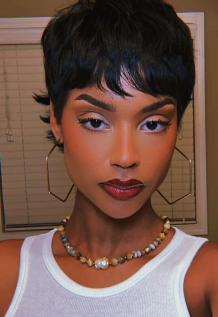 Beaded necklace with Tiger Eye and Jasper beads shown front facing worn by a model.